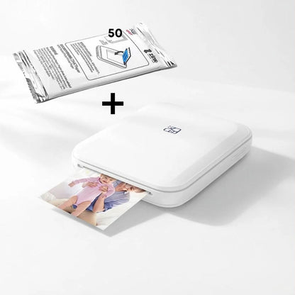 White photo printer with a sheet of printed photos and a pack of photo paper on a light gray background.